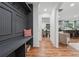 Inviting entryway with a gray mudroom area, hardwood floors, and view of kitchen and dining at 4327 Wellington Hills Ln, Snellville, GA 30039