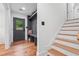 Entryway featuring wood floors, built-in bench, and staircase at 4327 Wellington Hills Ln, Snellville, GA 30039