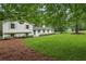 Well-maintained home exterior with lush greenery, a spacious lawn, and a quaint blue front door at 4327 Wellington Hills Ln, Snellville, GA 30039