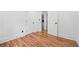 Hallway with hardwood floors and white walls leading to a bedroom at 4327 Wellington Hills Ln, Snellville, GA 30039