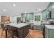 The kitchen has stainless appliances, an island with bar seating and hardwood floors at 4327 Wellington Hills Ln, Snellville, GA 30039
