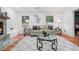 Bright living room with fireplace, hardwood floors, and stylish decor with large windows at 4327 Wellington Hills Ln, Snellville, GA 30039