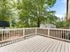 Back deck features white railing and view of trees in the backyard at 5438 Hiram Lithia Springs Rd, Powder Springs, GA 30127