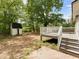 Backyard view features deck with stairs, a storage shed, and trees at 5438 Hiram Lithia Springs Rd, Powder Springs, GA 30127