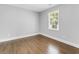 Bright bedroom features hardwood floors and a large window with natural light at 5438 Hiram Lithia Springs Rd, Powder Springs, GA 30127