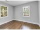 Corner bedroom featuring wood floors and two sunny windows at 5438 Hiram Lithia Springs Rd, Powder Springs, GA 30127