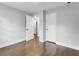 Bedroom featuring wood floors and two white doors, with one door open to hallway at 5438 Hiram Lithia Springs Rd, Powder Springs, GA 30127