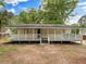 Inviting single-story home featuring a spacious front porch and a well-maintained yard at 5438 Hiram Lithia Springs Rd, Powder Springs, GA 30127
