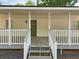 Inviting front porch featuring gray steps and railing, offering a charming welcome at 5438 Hiram Lithia Springs Rd, Powder Springs, GA 30127