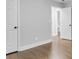 Hallway view features hardwood floors, white doors, and access to bathroom at 5438 Hiram Lithia Springs Rd, Powder Springs, GA 30127