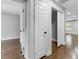 Hallway view features white doors, hardwood floors, and access to rooms at 5438 Hiram Lithia Springs Rd, Powder Springs, GA 30127