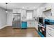 Modern kitchen with stainless steel appliances, white cabinets, and hardwood floors at 5438 Hiram Lithia Springs Rd, Powder Springs, GA 30127