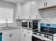Updated kitchen with white cabinets, granite countertops, and stainless steel appliances at 5438 Hiram Lithia Springs Rd, Powder Springs, GA 30127