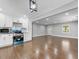 Bright open-concept living area with hardwood floors flowing into a stylish, modern kitchen at 5438 Hiram Lithia Springs Rd, Powder Springs, GA 30127