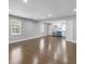 Open-concept living room with hardwood floors, recessed lighting, and a bright kitchen at 5438 Hiram Lithia Springs Rd, Powder Springs, GA 30127