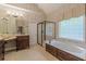 Luxurious bathroom features a jacuzzi tub, tiled flooring, a shower, and dual vanities at 9465 Grande Dr, Winston, GA 30187