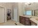 Cozy bathroom with a granite vanity, a framed mirror, and tiled flooring at 9465 Grande Dr, Winston, GA 30187