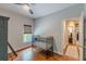 Comfortable bedroom with a metal crib, hardwood floors, neutral walls, and a window with blinds at 9465 Grande Dr, Winston, GA 30187