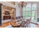 Elegant dining room featuring large windows, hardwood floors, and classic chandelier at 9465 Grande Dr, Winston, GA 30187