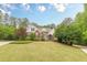 Stunning two-story brick home featuring lush landscaping, manicured lawn, and a welcoming facade at 9465 Grande Dr, Winston, GA 30187