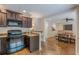 Eat-in kitchen flows into dining space with stained concrete floor and dark wood cabinets at 9465 Grande Dr, Winston, GA 30187