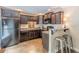 Compact kitchenette equipped with modern appliances, dark cabinetry, and a breakfast bar, ideal for casual dining at 9465 Grande Dr, Winston, GA 30187