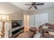 Cozy living room with a plush sofa set, hardwood floors, a ceiling fan, and neutral-colored walls at 9465 Grande Dr, Winston, GA 30187