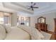 Comfortable main bedroom featuring a fireplace, a tray ceiling, and hardwood floors at 9465 Grande Dr, Winston, GA 30187