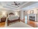 Elegant main bedroom features a tray ceiling, hardwood floors, and a fireplace at 9465 Grande Dr, Winston, GA 30187