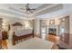 Spacious main bedroom featuring a tray ceiling, a fireplace, and hardwood floors at 9465 Grande Dr, Winston, GA 30187