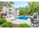 Back exterior view featuring in-ground pool with slide, diving board, and ample seating at 9465 Grande Dr, Winston, GA 30187