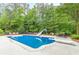 Refreshing in-ground pool, slide, diving board and lounge chairs for summer relaxation and enjoyment at 9465 Grande Dr, Winston, GA 30187