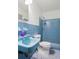 Bathroom with blue tile, toilet, vanity, and a walk-in shower, exhibiting a clean and functional design at 2732 Elkhorn Dr, Decatur, GA 30034