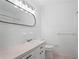 Bright bathroom featuring a white vanity with pink countertop and updated lighting fixture at 2732 Elkhorn Dr, Decatur, GA 30034