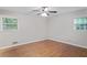 Bright bedroom with hardwood floors, neutral paint, and two windows that allow natural light at 2732 Elkhorn Dr, Decatur, GA 30034