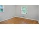 Bedroom with hardwood floors, one window with blinds, neutral walls and baseboards and electrical outlets at 2732 Elkhorn Dr, Decatur, GA 30034