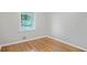 Cozy bedroom with hardwood floors, a window with blinds, and neutral walls for versatile decor options at 2732 Elkhorn Dr, Decatur, GA 30034