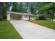 Exterior side view of a cozy one-story home with a spacious driveway and well-maintained lawn at 2732 Elkhorn Dr, Decatur, GA 30034