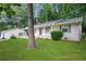 Side view of a charming single-story home with a lush lawn and a convenient covered carport at 2732 Elkhorn Dr, Decatur, GA 30034