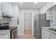Well-lit kitchen featuring stainless steel appliances, granite countertops, and classic white cabinets at 2732 Elkhorn Dr, Decatur, GA 30034