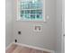 Laundry room with hardwood floors, a window, and washer/dryer hookups at 2732 Elkhorn Dr, Decatur, GA 30034