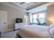 Well-lit primary bedroom with a tray ceiling, carpet and an in-room exercise bike at 834 S Columbia Dr, Decatur, GA 30030