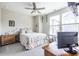 Cozy bedroom featuring a ceiling fan, modern decor, and natural light from the windows, creating a relaxing atmosphere at 834 S Columbia Dr, Decatur, GA 30030