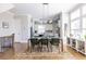 A dining area with a modern table, stylish chairs, and a view into the kitchen and lots of natural light at 834 S Columbia Dr, Decatur, GA 30030