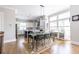 Bright dining area with hardwood floors, modern light fixtures, and a view to the kitchen and windows at 834 S Columbia Dr, Decatur, GA 30030