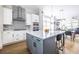 Bright open kitchen features white cabinets, gray island, stainless appliances and decorative backsplash at 834 S Columbia Dr, Decatur, GA 30030