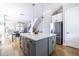 Open concept living area featuring modern kitchen with island that seamlessly transitions into dining and living spaces at 834 S Columbia Dr, Decatur, GA 30030