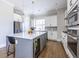 Contemporary kitchen with gray island featuring quartz countertop, stainless appliances, and custom cabinets at 834 S Columbia Dr, Decatur, GA 30030