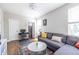 Cozy living room with a gray sectional sofa, decorative rug, and adjacent workspace at 834 S Columbia Dr, Decatur, GA 30030