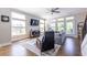 Bright living room features hardwood floors, a ceiling fan, and multiple large windows overlooking the yard at 834 S Columbia Dr, Decatur, GA 30030
